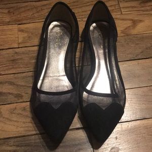 Heart tipped black flats.